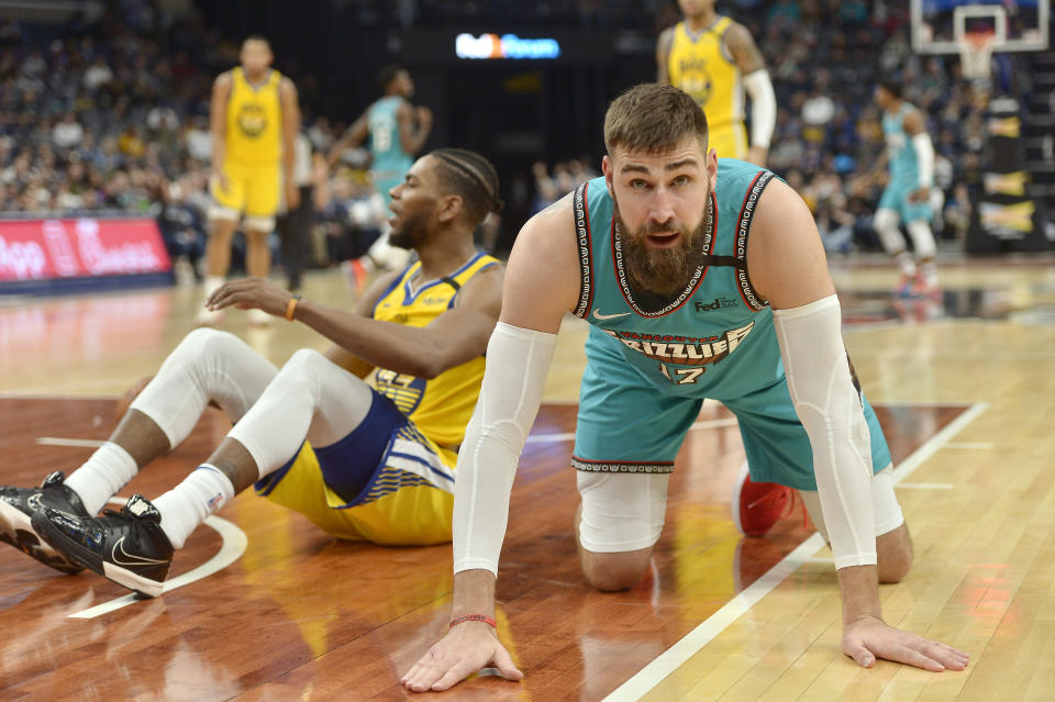 Memphis Grizzlies center Jonas Valanciunas (17) kneels on the court after forcing a jump ball against Golden State Warriors forward Glenn Robinson III (22) in the second half of an NBA basketball game Sunday, Jan. 12, 2020, in Memphis, Tenn. (AP Photo/Brandon Dill)