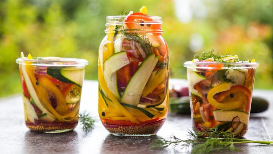 The best foods to eat for gut health: Pickeled vegetables and herbs in preserving jars
