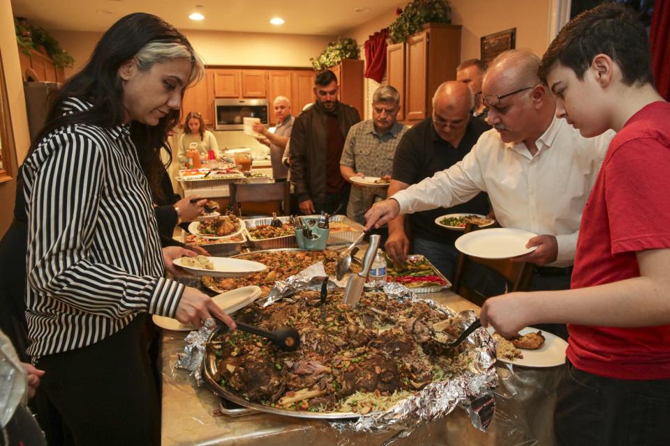 Members of the extended Fejleh family have dinner after breaking their fast with a date and prayers at home in Montclair.