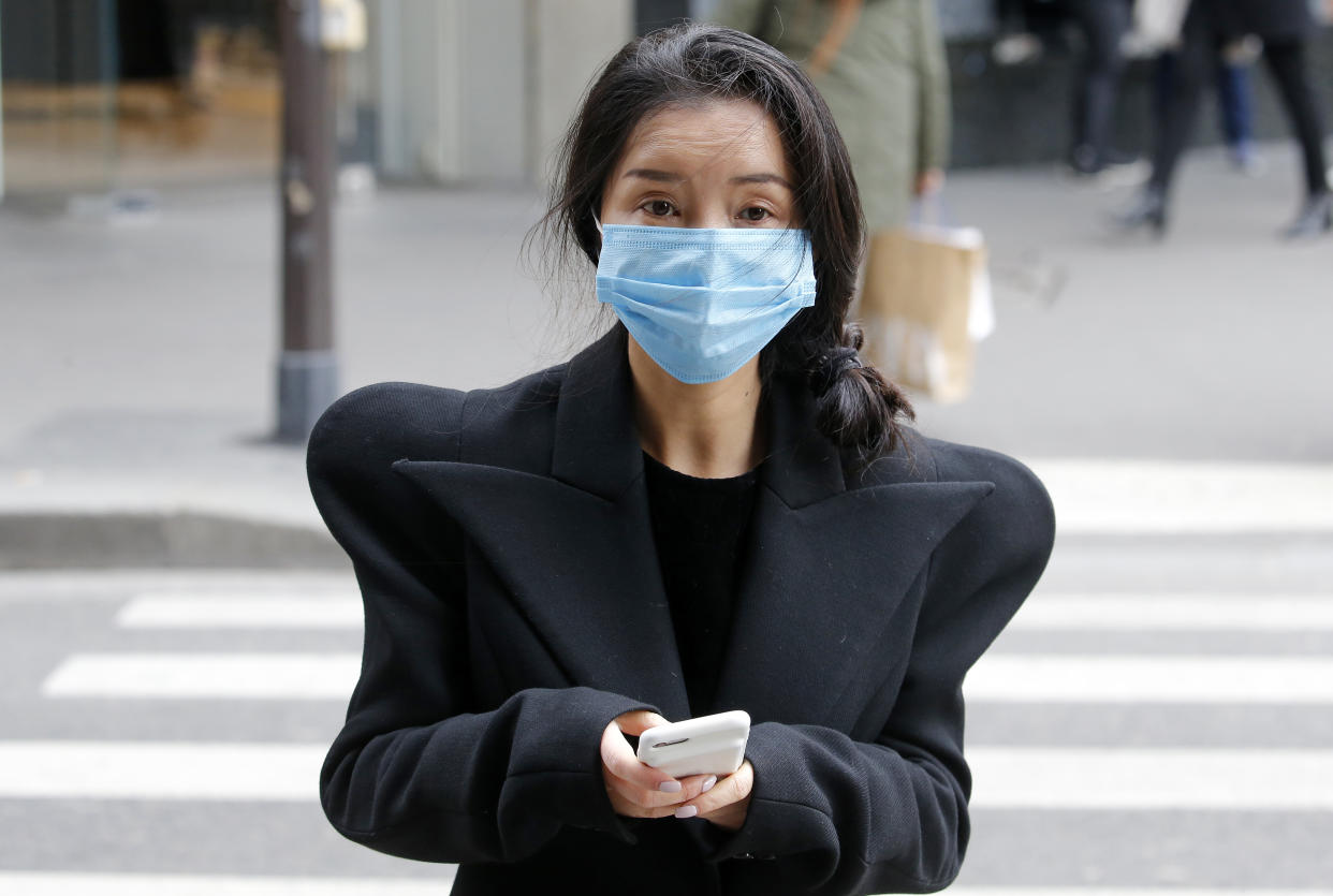 PARIS, FRANCE - MARCH 04: A woman wearing a protective mask looks on as walking the streets of Paris on March 4, 2020 in Paris, France. Due to a sharp increase in the number of cases of coronavirus (COVID-19) declared in Paris and throughout France, several sporting, cultural and festive events have been postponed or canceled. The epidemic has exceeded 3,000 dead for more than 86,000 infections in sixty countries. In France, 130 cases are now confirmed, in 13 regions in total. (Photo by Chesnot/Getty Images)