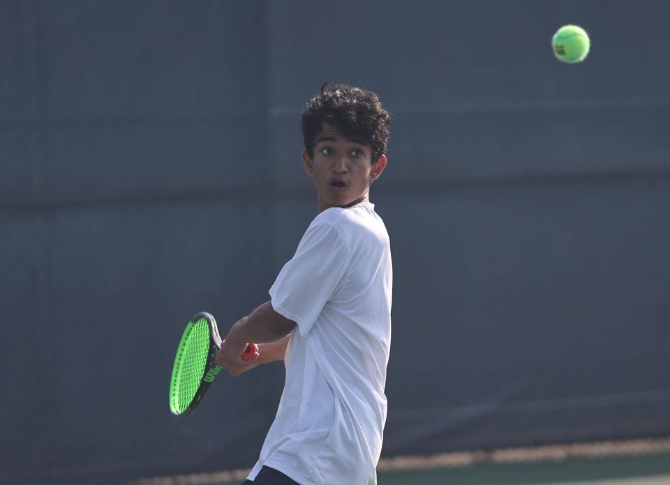 Avi Mahajan of Seven Hills competes during the singles match at the district tennis tournament Saturday, May 21, 2022, at the Lindner Family Tennis Center.