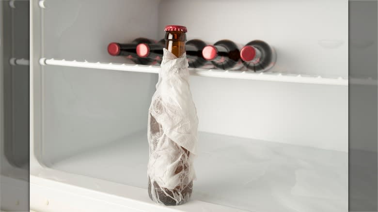 Wet paper towel wrapped bottle