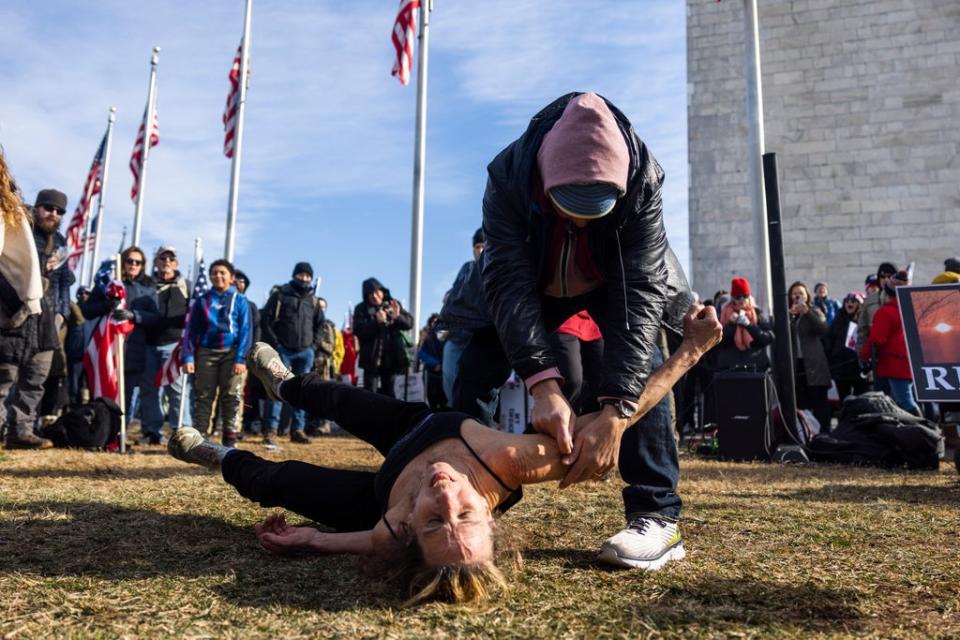 Anti-vaccine and mask activists act out getting a vaccine during a 'Defeat the Mandates' rally on  the National Mall in Washington, DC, USA, 23 January 2022. Several thousand protesters attended the event, despite the Covid-19 vaccines proving to be safe and effective. (EPA)