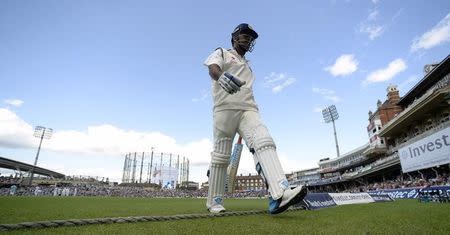 India's captain Mahendra Singh Dhoni leaves the field after being dismissed for a duck during the fifth test cricket match against England at the Oval cricket ground in London August 17, 2014. REUTERS/Philip Brown