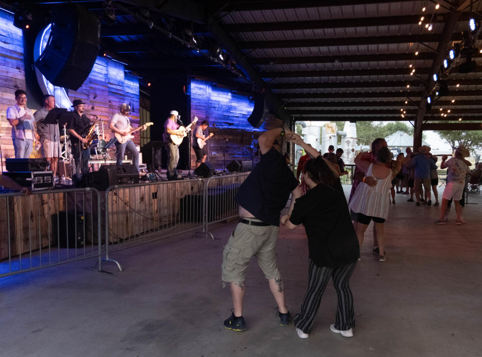 A dance partner gets turned around Saturday evening at the 1st annual Calf Fry Festival at the Starlight Ranch Event Center in Amarillo.