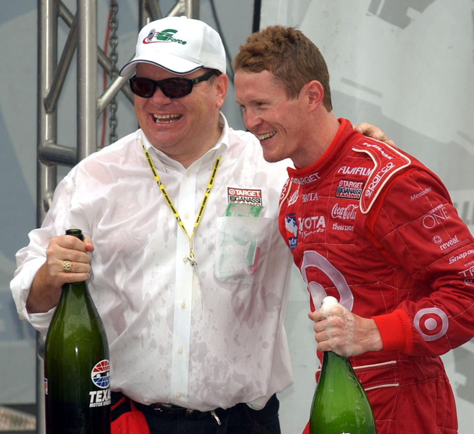 FILE - In this Sunday, Oct. 12, 2003, file photo, team owner Chip Ganassi, left, and 2003 IRL champion Scott Dixon, right, celebrate following the IRL Chevy 500 race at Texas Motor Speedway in Fort Worth, Texas. Ganassi knew Dixon as a quiet kid in a paddock full of superstars when he hired him four races into the 2002 season. (AP Photo/Tony Gutierrez, File)