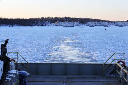 The Warren Jr., a 150 foot offshore supply boat, cuts a path through the ice as it works as an ice breaker for the commuter ferry in the waters off Hingham, Massachusetts March 3, 2015. REUTERS/Brian Snyder