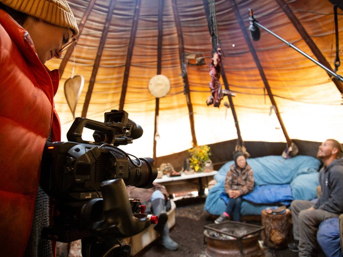 On the set of 'Okpik: Little Village in the Arctic,' one of the films that will be screened this week at the  Łı́ı́dlı̨ı̨ Kų́ę́ Film Festival in Fort Simpson, N.W.T. Caroline Cox is behind the camera, filming Kylik Kisoun and Elsie Ovilok.  (Submitted by Kelly Kamo McHugh - image credit)