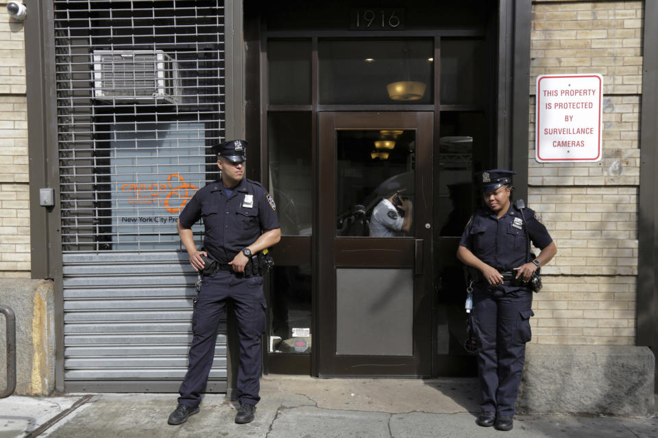 CORRECTS TO LOCATION HARLEM NOT BROOKLYN - FILE - In this Thursday, June 21, 2018 file photo, police stand outside an office for the Cayuga Centers in the the Harlem neighborhood of New York. Three of the four incidents involving physical harm to separated immigrant children, outlined in legal filings, involved charges of Cayuga Centers, the largest foster care placement for migrant children. (AP Photo/Richard Drew)