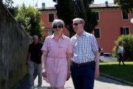 Britain's Prime Minister Theresa May walks with her husband Philip in Desenzano del Garda, by Lake Garda, northern Italy, July 25, 2017. REUTERS/Antonio Calanni/Pool