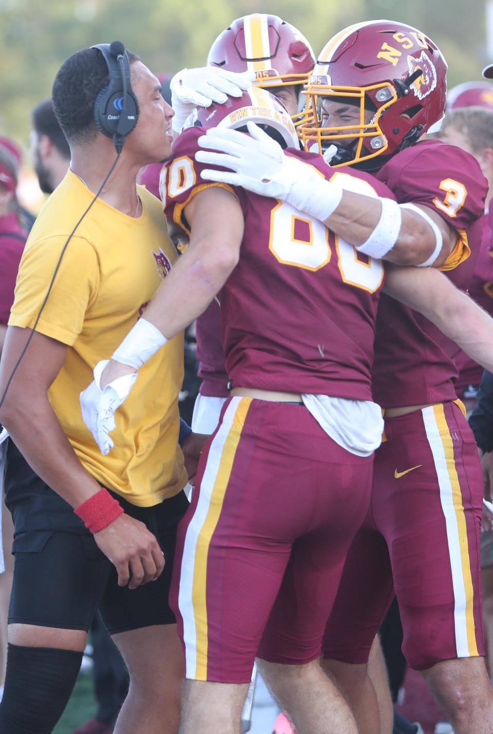 Northern State coaches and teammates celebrate with wide receiver Caleb Schentzel (80) after he caught a 22-yard touchdown pass from quarterback Michael Bonds in the second quarter to give the Wolves a 13-0 lead against Upper Iowa. Northern won Thursday's game at Dacotah Bank Stadium 30-0.