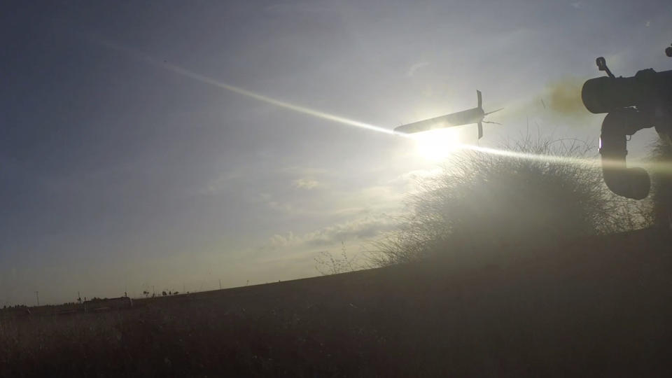 In this image from body camera video during the Oct. 7, 2023, surprise attack on Israel, a Hamas fighter fires a Russian-designed 9M32 Strela anti-aircraft missile at an unseen target, with the sun in the background. Weapons experts told The Associated Press the grip-stock seen on the missile launcher the fighter was holding is distinctive to a variant recently manufactured in China and used by the Iranian military and its allies, including Hezbollah in Lebanon, a group closely aligned with Hamas. (South First Responders via AP)