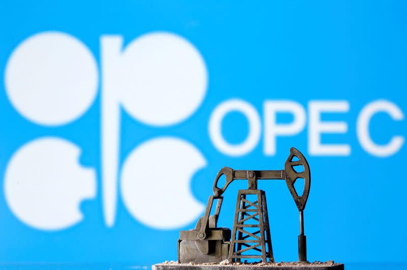 A 3D printed oil pump jack is seen in front of displayed Opec logo in this illustration picture