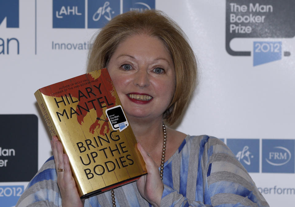 FILE - Hilary Mantel, winner of the Man Booker Prize for Fiction, poses with a copy of her book 'Bring up the Bodies', shortly after the award ceremony in central London, on Oct. 16, 2012. Mantel, the Booker Prize-winning author of the acclaimed “Wolf Hall” saga, has died, publisher HarperCollins said Friday Sept. 23, 2022. She was 70. (AP Photo/Lefteris Pitarakis, File)