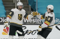 Vegas Golden Knights right wing Alex Tuch, left, is congratulated by center Cody Glass (9) after scoring against the San Jose Sharks during the second period of an NHL hockey game in San Jose, Calif., Saturday, March 6, 2021. (AP Photo/Jeff Chiu)