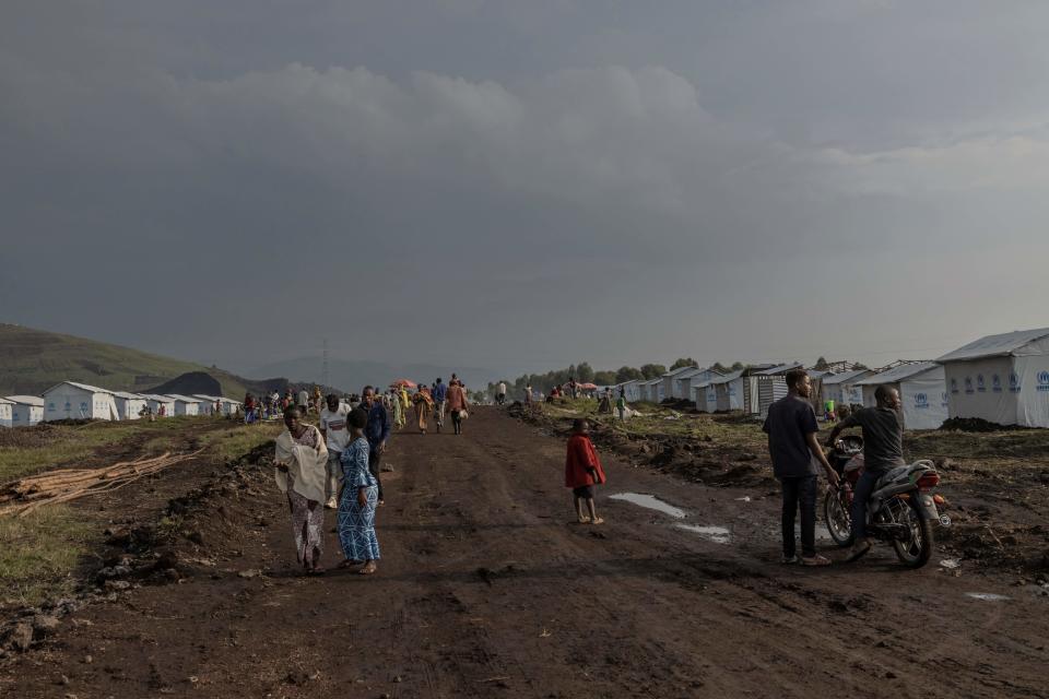 Internally displaced people walk on a road at the Bushagara site, north of the city of Goma in eastern Democratic Republic of Congo, on Jan. 13, 2023. / Credit: GUERCHOM NDEBO/AFP via Getty Images