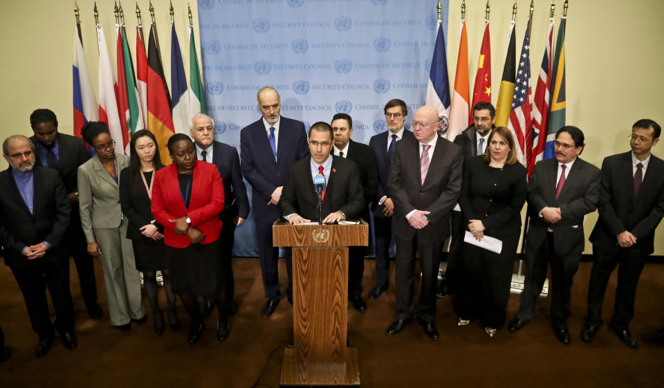 Venezuela Foreign Affairs Minister Jorge Arreaza, center, is surrounded by diplomats from several countries including Russia, China, Iran and Syria, while holding a press conference at United Nations headquarters, Thursday Feb. 14, 2019. (AP Photo/Bebeto Matthews)