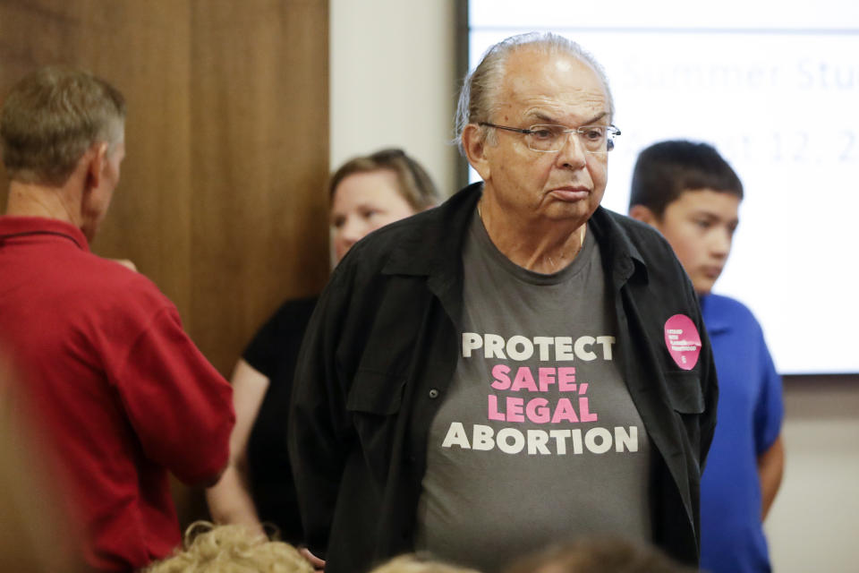 People wait for the start of a Senate hearing to discuss a fetal heartbeat abortion ban, or possibly something more restrictive, Monday, Aug. 12, 2019, in Nashville, Tenn. (AP Photo/Mark Humphrey)