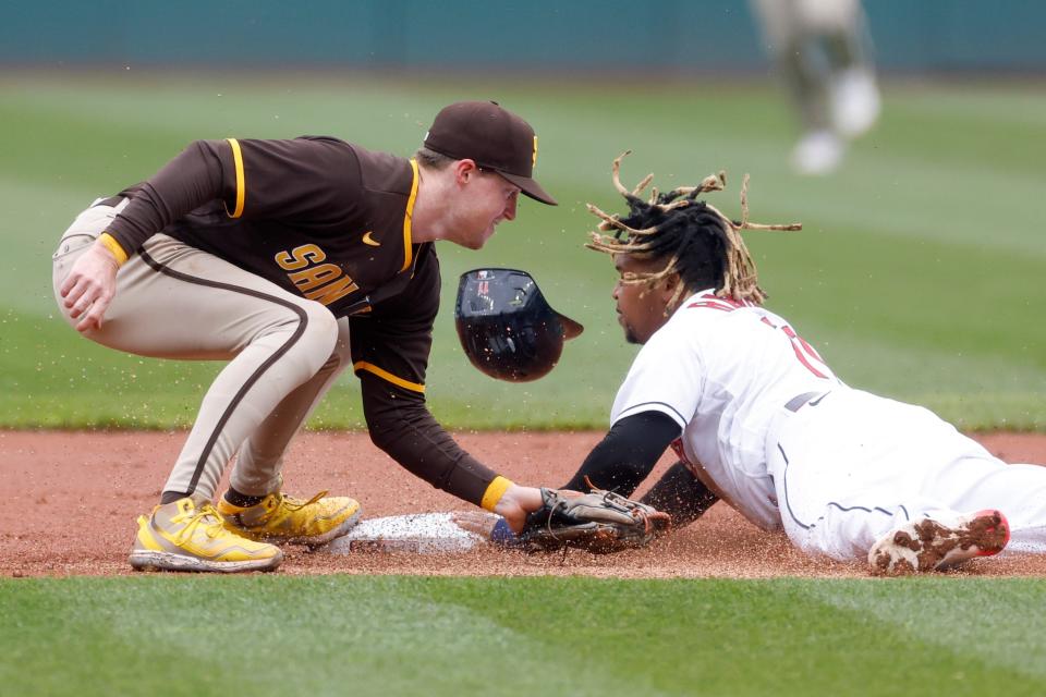 Cleveland Guardians' Jose Rami­rez, right, steals second base as San Diego Padres' Jake Cronenworth attempts is late with tag during the first inning in the first baseball game of a doubleheader, Wednesday, May 4, 2022, in Cleveland. (AP Photo/Ron Schwane)