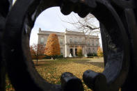 This Nov. 19, 2010 file photo shows the Elms mansion as seen through an opening in an iron fence, in Newport, R.I. Newly discovered photographs, documents and family histories have inspired the creation of a tour about servants at The Elms, echoing themes of the British drama program, "Downton Abbey." (AP Photo/Steven Senne, File)