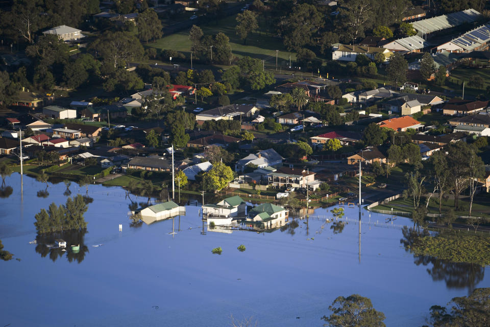 Buildings are partially submerged in a floodwater in the Windsor area, northwest of Sydney, Australia, Wednesday, March 24, 2021. Some 18,000 residents of Australia's most populous state have fled their homes since last week, with warnings the flood cleanup could stretch into April. (Lukas Coch/Pool Photo via AP)
