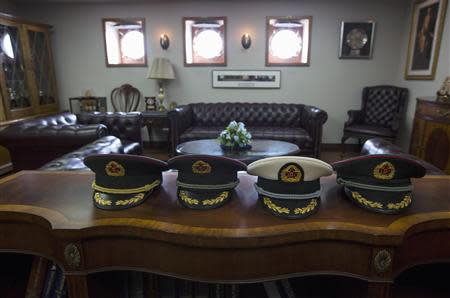 China's People's Liberation Army (PLA) personnel leave their hats during a tour of the U.S. Navy aircraft carrier George Washington in the South China Sea November 7, 2013. REUTERS/Tyrone Siu