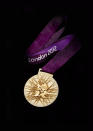 LONDON, UNITED KINGDOM -JULY 27: This handout image supplied by The London Organising Committee of the Olympic and Paralympic Games (LOCOG), shows the medals that will be awarded in the London 2012 Olympic Games, designed by British artist David Watkins. The medal depicts 'Nike', the Greek Goddess of Sport, stepping out of a scene depicting of the Parthenon and Panathinaiko Stadium. The one year countdown to the London 2012 Olympic games was marked with a unique ceremony in Trafalgar Square, with IOC President Jacques Rogge inviting the world's athletes to compete in next summer's games. (Photo by LOCOG via Getty Images)