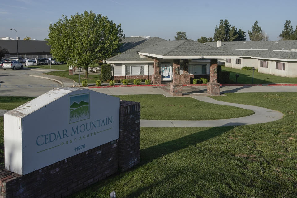 A sign marks at an entrance to the Cedar Mountain Post Acute nursing facility in Yucaipa, Calif., Wednesday, April 1, 2020. The Southern California nursing home has been hit hard by the coronavirus, with more than 50 residents infected, a troubling development amid cautious optimism that cases in the state may peak more slowly than expected. (AP Photo/Chris Carlson)