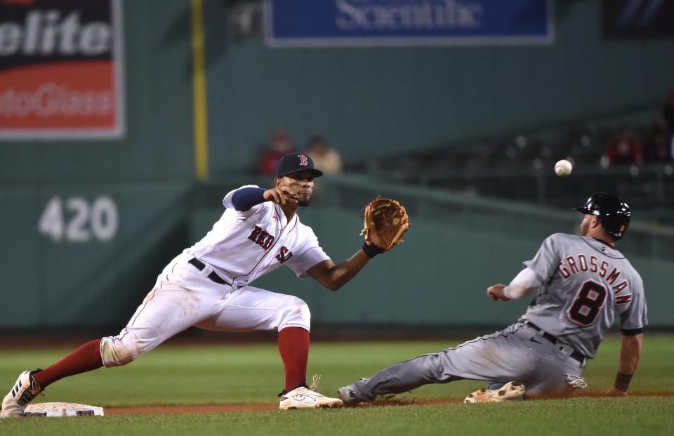 Detroit Tigers left fielder Robbie Grossman (8) steals second base and takes third when Boston Red Sox shortstop Xander Bogaerts (2) misses the ball during the sixth inning at Fenway Park in Boston on Tuesday, May 4, 2021.