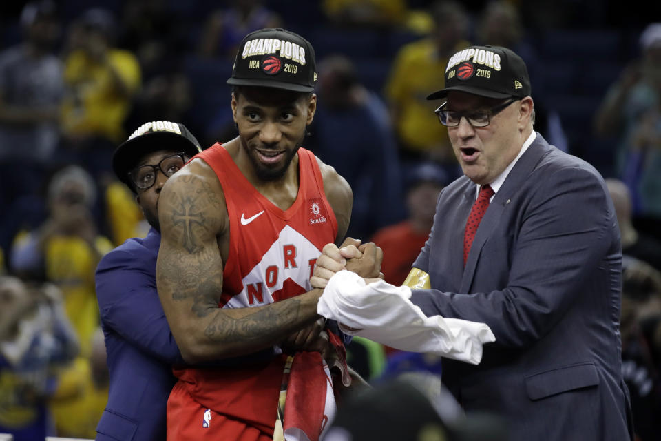 Toronto Raptors forward Kawhi Leonard, center, celebrates after the Raptors defeated the Golden State Warriors in Game 6 of basketball's NBA Finals in Oakland, Calif., Thursday, June 13, 2019. (AP Photo/Ben Margot)