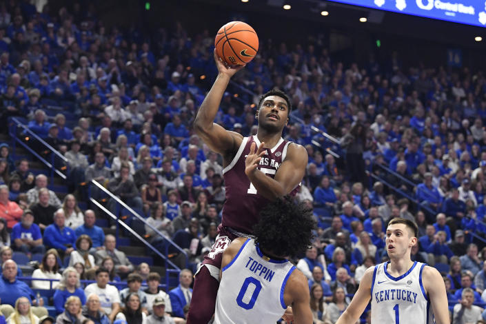 Texas A&M forward Henry Coleman III (15) goes up for a shot over Kentucky forward Jacob Toppin (0) during the first half of an NCAA college basketball game in Lexington, Ky., Saturday, Jan. 21, 2023. (AP Photo/Timothy D. Easley)