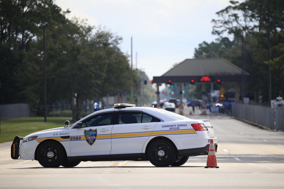 The Jacksonville Sheriff's office blocks the scene of a crash that killed a man Thursday trying to get through a barrier at Naval Air Station Jacksonville's Birmingham Gate.