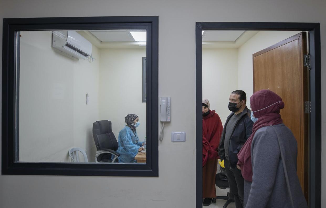<span class="caption">Palestinian patients infected with COVID-19 registering at an emergency unit in the West Bank city of Ramallah.</span> <span class="attribution"><a class="link " href="https://newsroom.ap.org/detail/VirusOutbreakPalestinians/e87910359a00478f849b8212e2764d85/photo?Query=palestine%20AND%20covid&mediaType=photo&sortBy=arrivaldatetime:desc&dateRange=Anytime&totalCount=14&currentItemNo=2" rel="nofollow noopener" target="_blank" data-ylk="slk:AP Photo/Nasser Nasser;elm:context_link;itc:0;sec:content-canvas">AP Photo/Nasser Nasser</a></span>