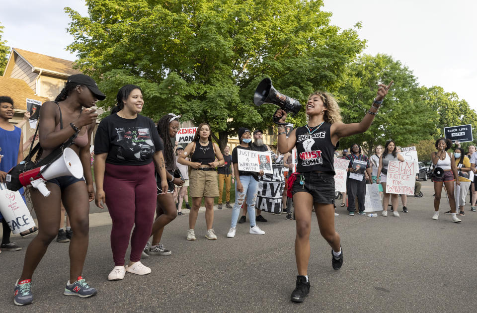 Protesters demonstrate outside of the home of U.S. Marshal Ramona Dohman, Tuesday, June 8, 2021, in Minneapolis, in protest of the fatal shooting of Winston Boogie Smith Jr., the week before. The two sheriff’s deputies who shot and killed Smith while assigned to a U.S. Marshals Service fugitive task force had been told they could not use their body-worn cameras. That's despite a change in Justice Department policy to allow cameras months before the shooting. (Carlos Gonzalez/Star Tribune via AP)