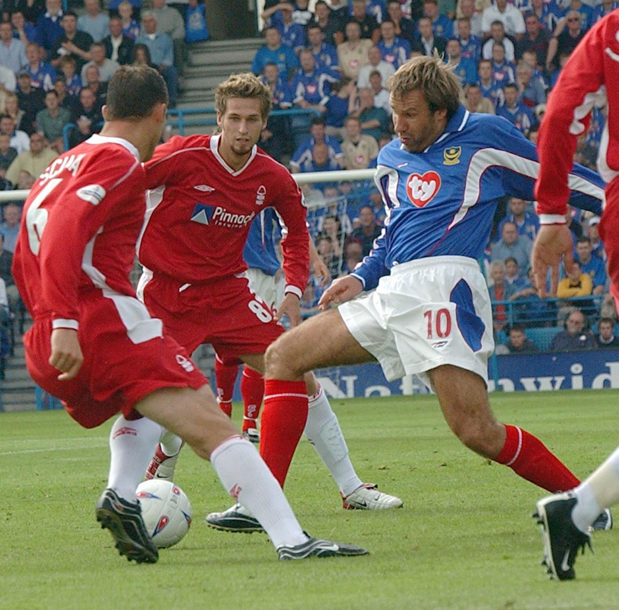 Portsmouth footballer Paul Merson challenges Nottingham Forest's Riccardo Scimeca