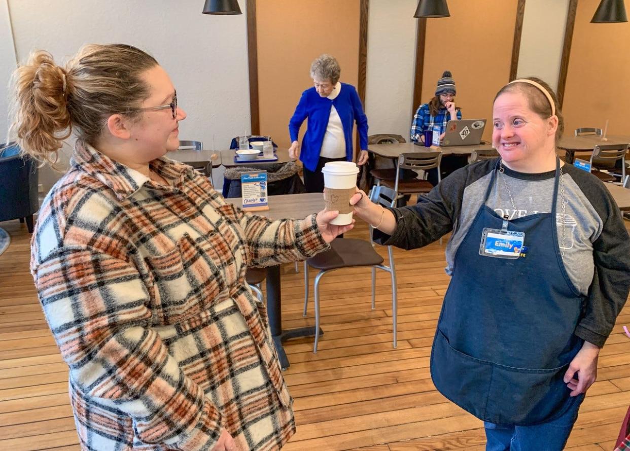 Emily Kehlmeier, right, has been working at Christy’s Corner Café since it opened. Here, she serves a coffee to a customer.