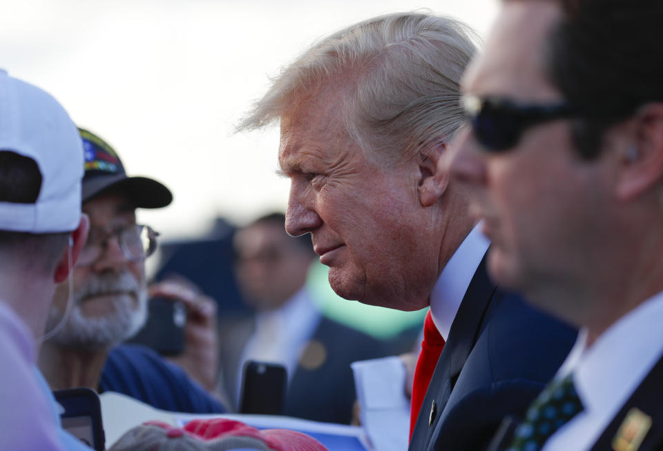 President Donald Trump leans in to listen to his supporters on the tarmac upon his arrival at Palm Beach International Airport, Thursday, April 18, 2019, in West Palm Beach, Fla. Trump traveled to Florida to spend the Easter weekend as his Mar-a-Lago estate. (AP Photo/Pablo Martinez Monsivais)