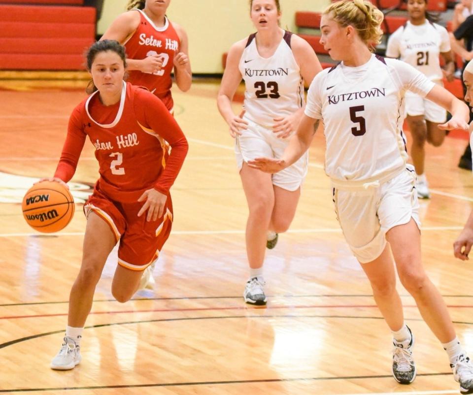 Seton Hill guard Christiane Frye makes a move with the ball as a Kutztown defender attempts to defend in PSAC action this season.