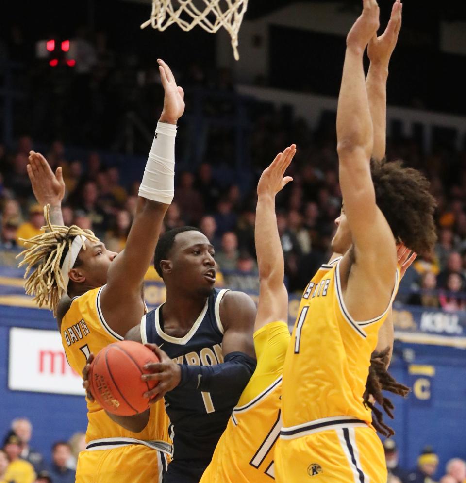 Akron's Garvin Clarke looks to pass as Kent State's VonCameron Davis, Jalen Sullinger and Chris Payton defend at the M.A.C. Center in Kent on Friday.