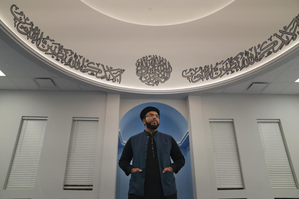 Tariq Naseem, imam for the Zion Ahmadiyya Muslim community, stands for a portrait in the newly constructed Fath-e-Azeem mosque in Zion, Ill., on Thursday, Sept. 15, 2022. The Ahmadis' view this small-sized city, 40 miles north of Chicago, as a place of special religious significance for their global messianic faith after a century-old prayer duel between prophet and founder of the Ahmadi movement and the founder of Zion. (AP Photo/Jessie Wardarski)