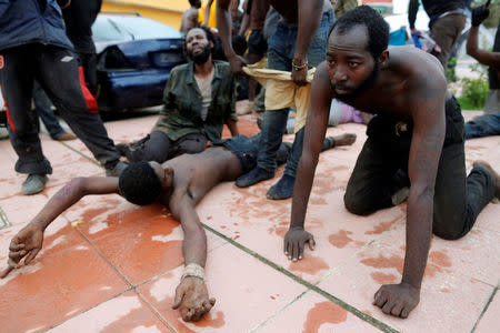 African migrants rest after crossing a border fence between Morocco and Spain's north African enclave of Ceuta October 31, 2016. REUTERS/M. Martin