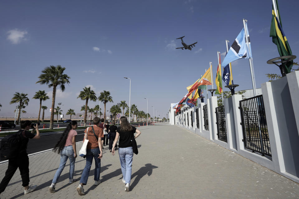 Climate activists leave a designated protest zone as a plane flies overhead during the COP27 U.N. Climate Summit, Tuesday, Nov. 15, 2022, in Sharm el-Sheikh, Egypt. (AP Photo/Nariman El-Mofty)