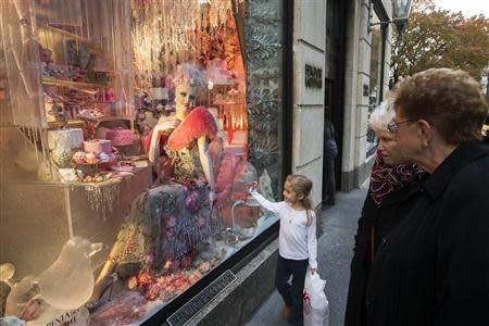 A girl looks at a predominantly pink holiday window display at the Bergdorf Goodman store in New York, November 22, 2013. REUTERS/Lucas Jackson