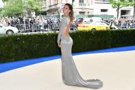 <p>The supermodel and co-chair of the 2017 Met Gala wore a sustainable, backless metallic gown by designer Stella McCartney. She styled her hair in a high ponytail. (Photo: Rob Latour/REX) </p>