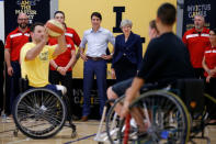 Canada's Prime Minister Justin Trudeau and Britain's Prime Minister Theresa May watch a wheelchair basketball demonstration during an Invictus Games event at Lisgar Collegiate Institute in Ottawa, Ontario, Canada, September 18, 2017. REUTERS/Chris Wattie