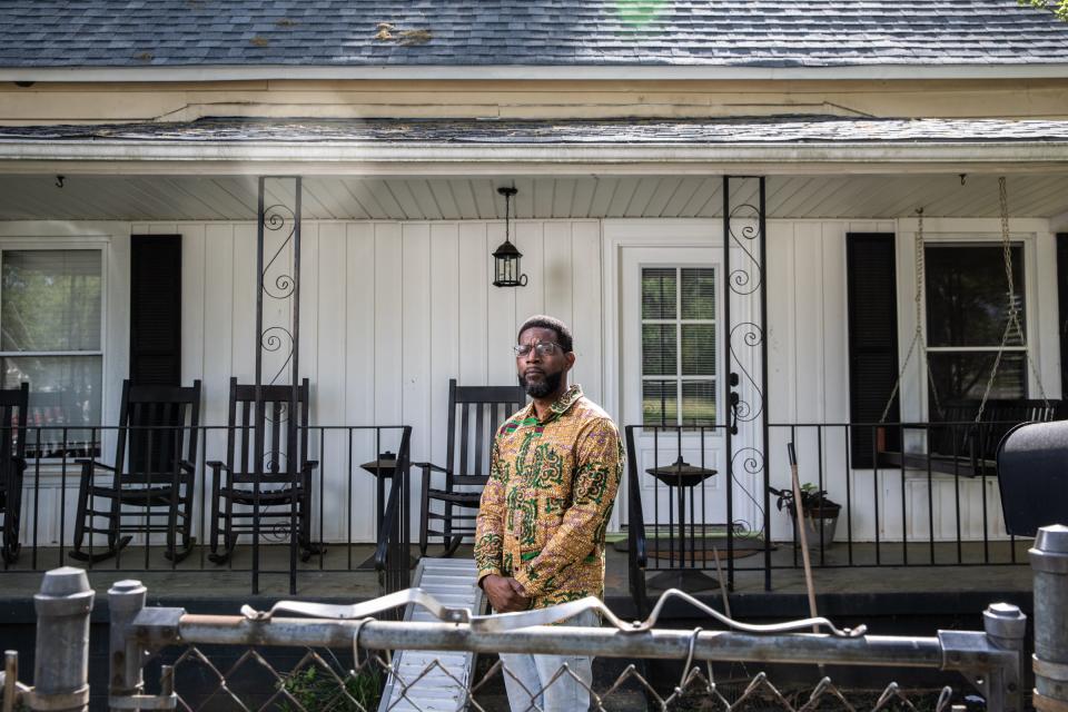 Kwadjo Campbell, president of the Poe Mill neighborhood association, in front of his home on 2nd Avenue, Friday, April 16, 2021.