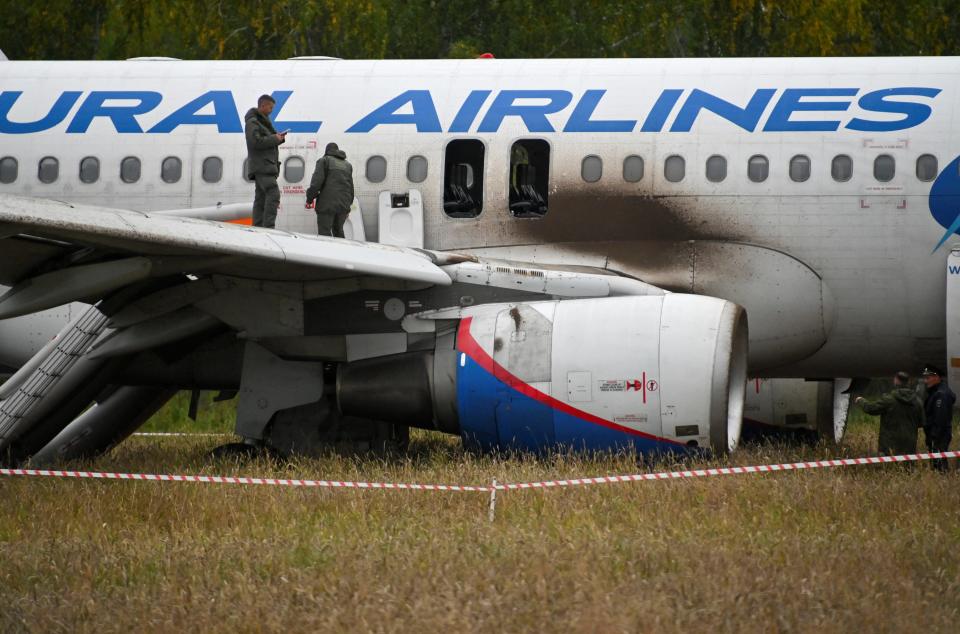 Investigators work at the accident scene after an Airbus A320 passenger plane of Russia's Ural Airlines made an emergency landing in a field near the settlement of Kamenka in the Novosibirsk region, Russia, September 12, 2023.