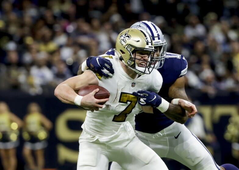 New Orleans Saints quarterback Taysom Hill (7) is sacked by Dallas Cowboys outside linebacker Micah Parsons.