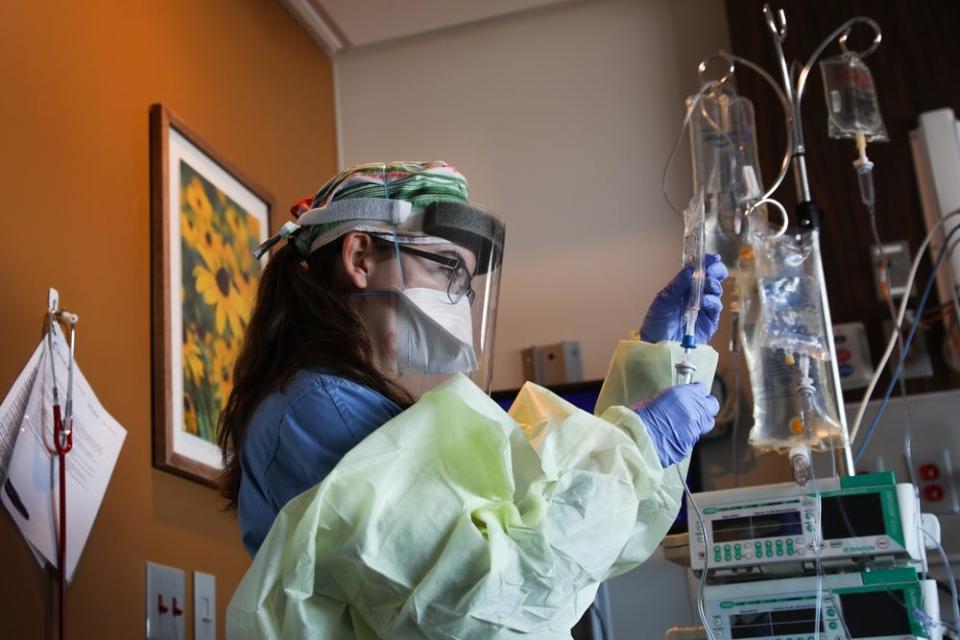 U.S. Air Force 2nd Lt. Kathleen Todd, a clinical nurse assigned to a medical response team deployed to St. Cloud, Minnesota, prepares a new IV drip for a patient at St. Cloud Hospital, Jan. 19, 2022. The medical response team was deployed to the hospital in support of the continued Department of Defense COVID response operations to help communities in need. U.S. Northern Command, through U.S. Army North, remains committed to providing flexible Department of Defense support to the whole-of-government COVID response.