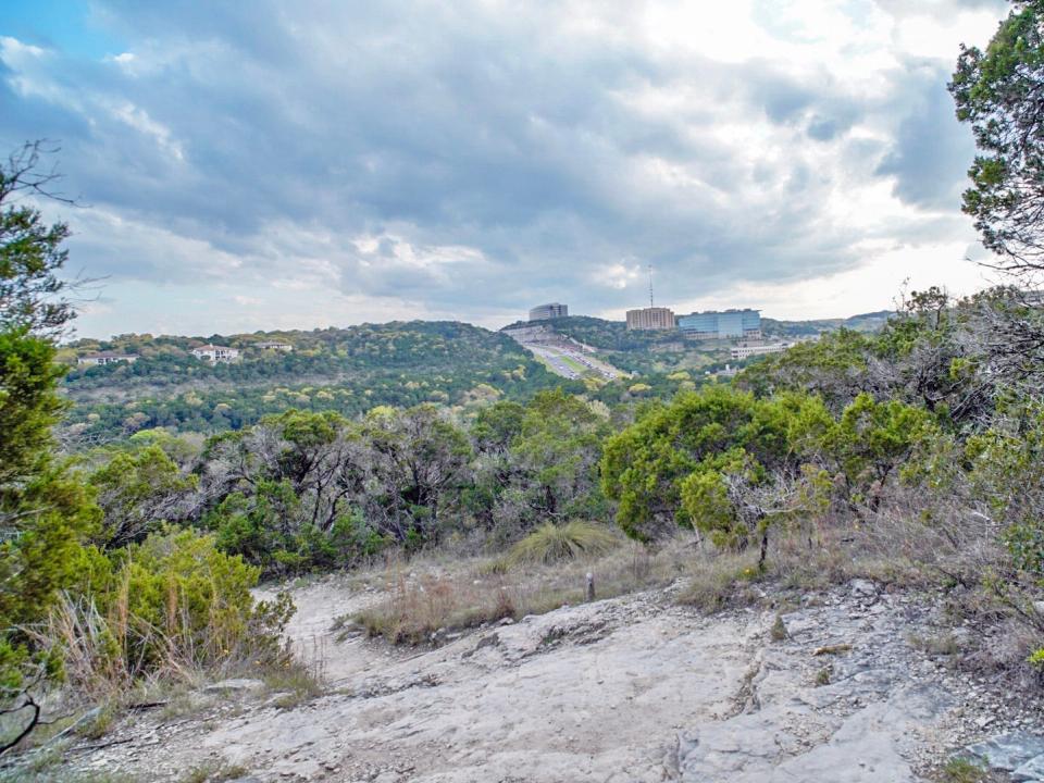 A wide shot of hill country in Austin's Wild Basin Wilderness Preserve on a cloudy day